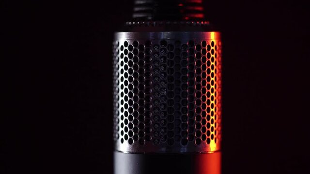 Close up shot of Electrical hand-held hair dryer for hair salon or barber shop on black background. Red light illuminates contours of hair dryer. Epic shots are suitable for commercial advertising