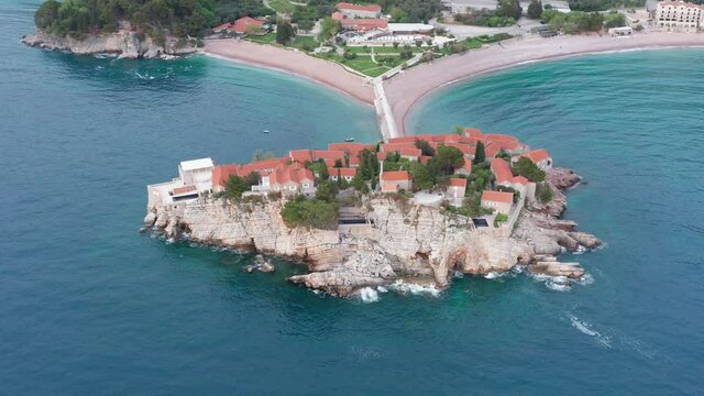 Sveti Stefan island by the Adriatic coast in Montenegro, on the Mediterranean. St Stephen is hotel and resort on an isle amidst blue sea and famous summer vacations destination.