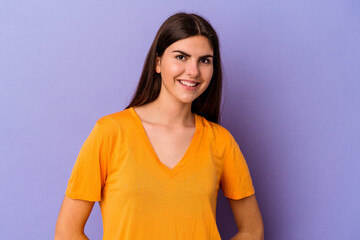 Obraz premium Young caucasian woman isolated on purple background happy, smiling and cheerful.