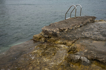 Fototapeta premium Concept of ladder in a natural pool