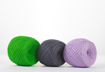 Close-up shot of colorful balls of woolen yarn isolated on white