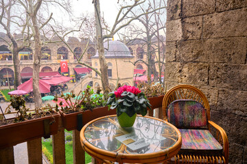 29.03.2021. Bursa. Turkey. Inside the kozahan in Bursa and vintage style table and armchair made of wooden and glass material and there is masjid inside the kozahan © SKahraman