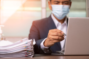 businessman in suit is seriously reading coronavirus cases.