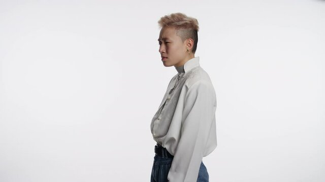 Portrait of an Asian hipster hardly able to believe what they heard