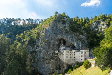 Fototapeta na wymiar Castle Predjama at summer, Stone castle in Slovenia