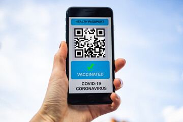 health Vaccine Passport for Coronavirus or Covid-19. Traveller Using Mobile Phone with Vaccination in Immune Status to Certificated International Traveling in Airport