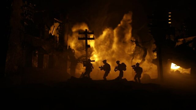 Military soldiers silhouettes with bazooka and rpg. War Concept. Military silhouettes fighting scene on war fog sky background, Mojahed with rpg and us soldier with bazooka at sunset. Attack scene