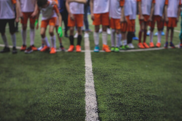 Football soccer game for kids, junior young football team group of children team having training...