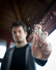 young man using a spray, a guy cleaning something with spray, to spray on something