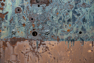 bullet marks on an old rusty soviet bunker door