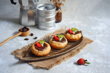a plate of chocolate egg tart on the table