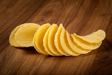 Delicious crispy potato chips on the table.