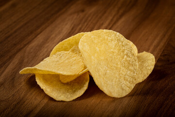 Delicious crispy potato chips on the table.