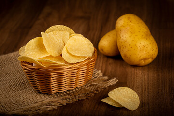 Delicious crispy potato chips on the table.