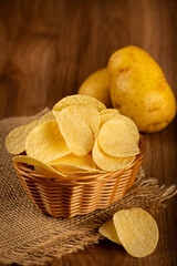 Delicious crispy potato chips on the table.