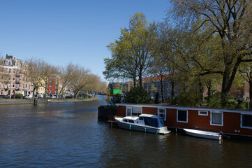 A warm sunny spring day in downtown Amsterdam Holland along the canal system.