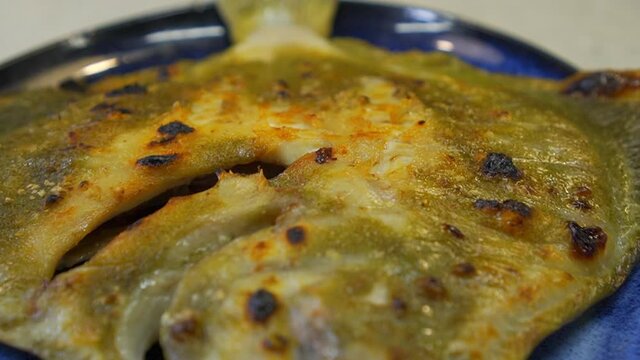 Grilled turbot with garlic and butter sauce, lemon and aromatic herbs