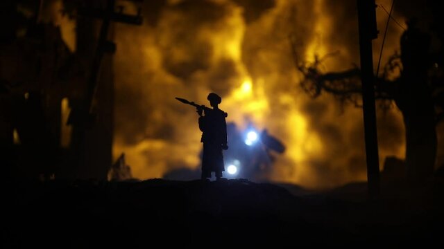 Military soldiers silhouettes with bazooka and rpg. War Concept. Military silhouettes fighting scene on war fog sky background, Mojahed with rpg and us soldier with bazooka at sunset. Attack scene