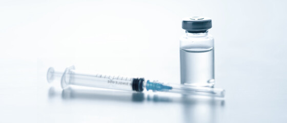 Medical syringe with a needle and a bollte with vaccine. - obrazy, fototapety, plakaty