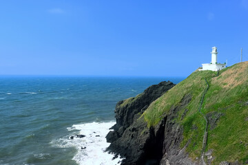 Fototapeta na wymiar 海 水平線と岬の灯台