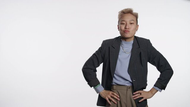 Portrait of an Asian person being funny on white