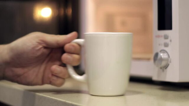 Using a microwave oven for heating a cup