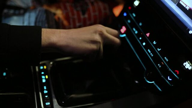 A man shifting gear on a Jaguar's sports car.