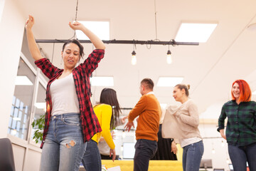 Fototapeta premium Team of successful multiethnic coworkers in modern office workplace dancing and celebrating success. Diversity happines concept