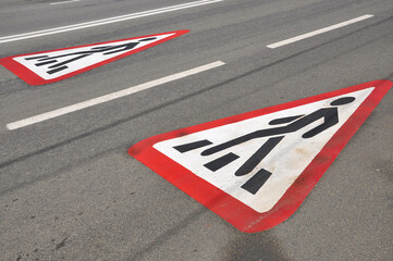 warning sign of a pedestrian crossing on the road. road signs.