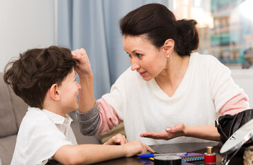 Fototapeta premium Strict woman having serious conversation with her preteen son at home..