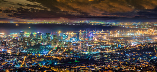 Naklejka premium Cape Town city and working harbor at night time, South Africa