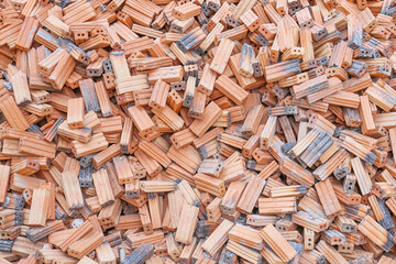 A pile of building materials, stack of new red bricks for construction