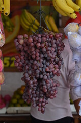 A bunch of ripe grapes hanging from Rawamangun market.