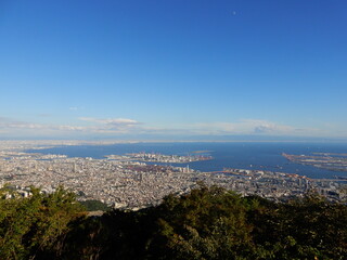摩耶山からの風景aerial view of kobe city from mount maya, Japan. sea with clear horizon and blue sky with clouds