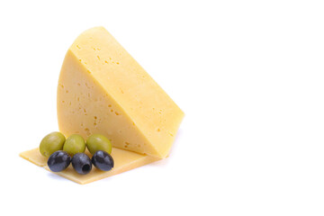A piece of hard yellow gouda cheese with olives close-up, isolated on a white background.selective focus