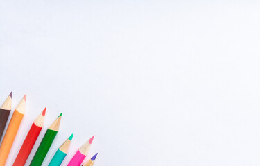 Colored pencils on a sheet of white paper. Selective focus. Backgrounds and textures.