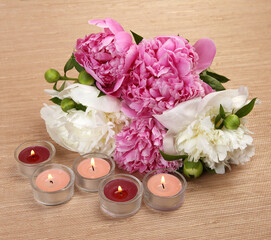 bouquet of peonies and candles
