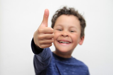 boy with thumbs up gesture on white background stock photo