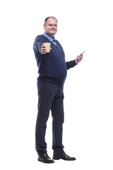 Mature man with a smartphone and a takeaway coffee.