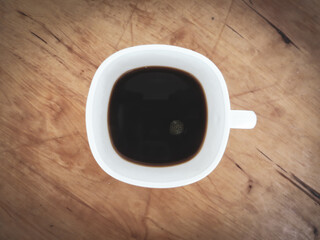 Black coffee in a white cup close-up.
