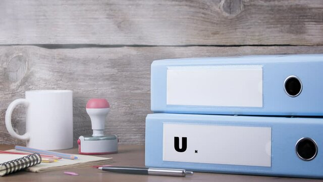 Paid and Unpaid. Office Binder on Wooden Desk