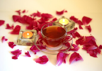 tea mug, candles and petals