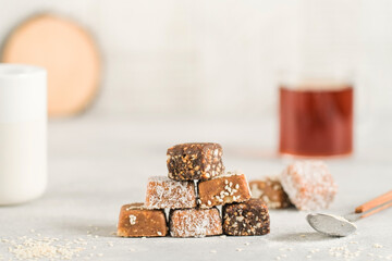 Stack of handmade vegan desserts made of dried fruits. Healthy raw vegetarian candies without sugar.