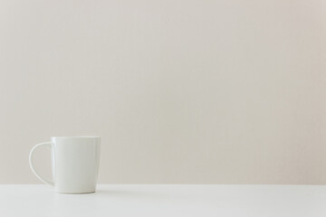 Fototapeta na wymiar A white coffee mug on table.