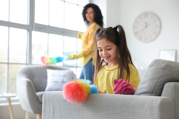 Mother and daughter cleaning their flat