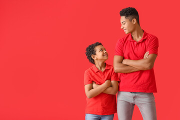 Portrait of African-American brothers on color background