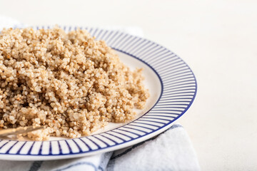 Plate with tasty quinoa on white background, closeup