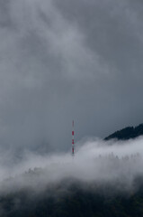 Clouds surrounding an antena in the mountain