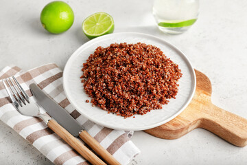 Composition with tasty quinoa and lime on light background
