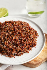 Plate with tasty quinoa on table, closeup